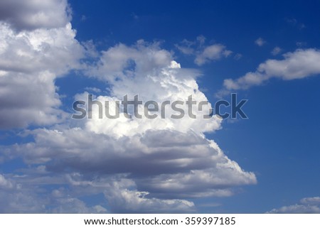 Masses of  majestic white fluffy cumulus  congestus or towering cumulus ice cream  clouds in a blue Australian sky in  summer are a portender of thunderstorm activity  likely to eventuate.
