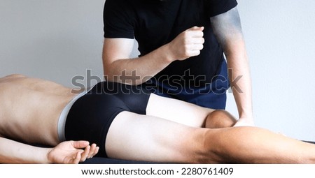 Masseur does sports legs massage in spa center. Massage of myofascial trigger points on leg of male client to release tension. Rehabilitation, sport therapy medicine. Piriformis muscle.