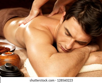 Masseur Doing Back Massage On Man Body In The Spa Salon. Beauty Treatment Concept.