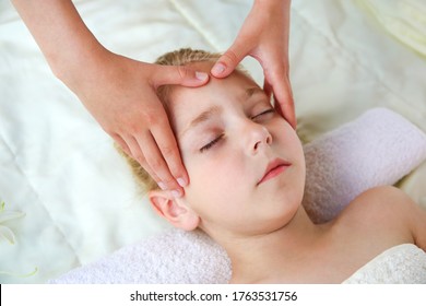 Masseur doing face massage to child. - Powered by Shutterstock