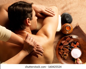 Masseur Doing Massage Of Backbone On Man Body In The Spa Salon. Beauty Treatment Concept.