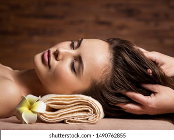 Masseur Doing Massage The Head And Hair For An Woman In Spa Salon