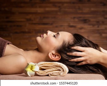 Masseur Doing Massage The Head And Hair For An Woman In Spa Salon