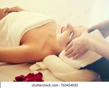 Masseur Doing Massage The Head Of An Woman In The Spa Salon