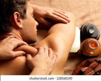 Masseur doing massage on man body in the spa salon. Beauty treatment concept. - Powered by Shutterstock