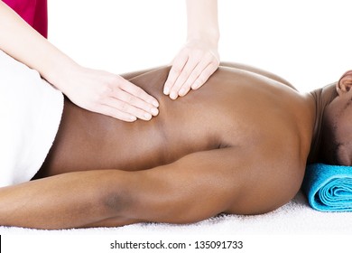 Masseur doing massage on man body in the spa salon.