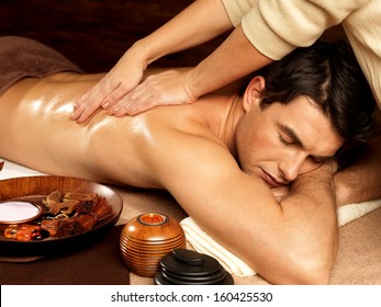 Masseur Doing Massage On Man Body In The Spa Salon. Beauty Treatment Concept.