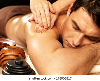 Masseur Doing Massage On Man Body In The Spa Salon. Beauty Treatment Concept.