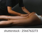 Masseur doing massage on woman body in the spa salon. Beauty treatment concept.