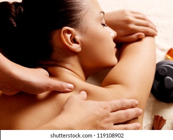 Masseur doing massage on woman body in the spa salon. Beauty treatment concept.