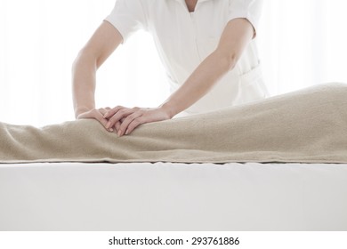 Masseur doing massage on woman body in the spa salon. - Shutterstock ID 293761886