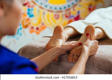 Masseur Doing Reflexology, Foot Massage In Exotic Spa