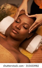 Masseur giving woman amazing scalp massage