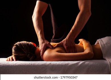 Masseur Hands Doing Back Massage To Client In Spa Center In Dark Room