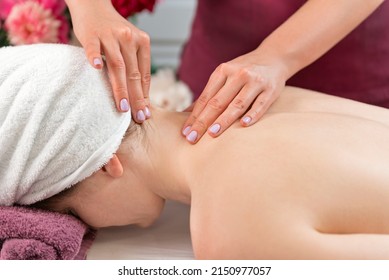 Masseur makes neck massage. Woman enjoying relaxing back massage in cosmetology spa centre. - Powered by Shutterstock