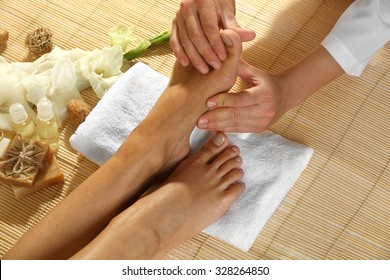 Masseur Making Feet Massage In Spa Salon