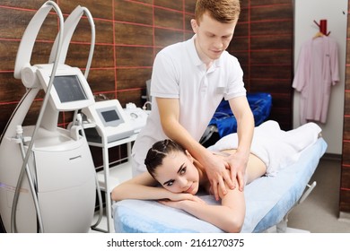 Masseur Man Doing Shoulder Girdle Massage To Attractive Young Woman