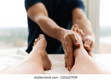 Masseur Man During Integrative Medicine Treatment - Female Foot Massage