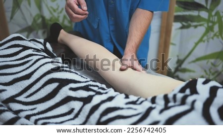 The masseur massages the girl's feet.