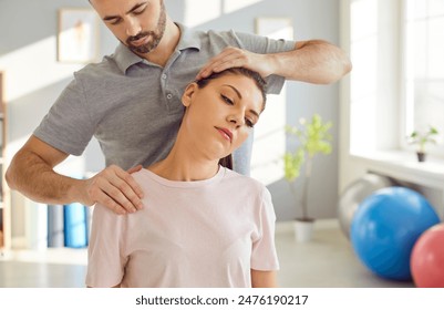 Masseur therapist specializing in physiotherapy and rehabilitation, providing a neck massage or stretching session for a patient in a medical office. Holistic approach to physical medicine. - Powered by Shutterstock