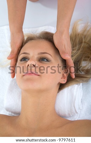 Similar – Young blond woman receiving a head massage