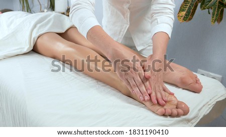 Hands massaging female abdomen.