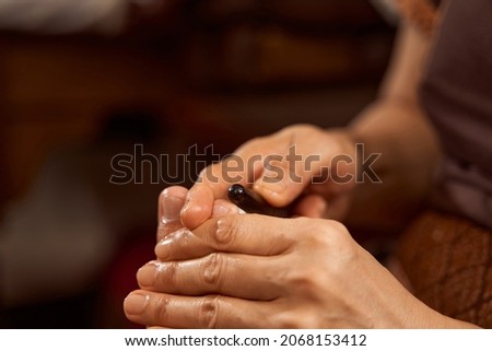 Masseuse giving foot massage to woman client
