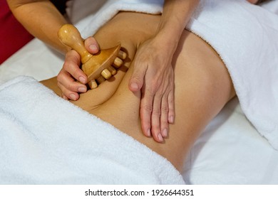 Masseuse Giving A Wood Massage Therapy Massage To A Client