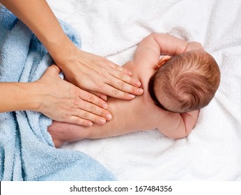 Masseuse massaging 5 months infant - Shutterstock ID 167484356