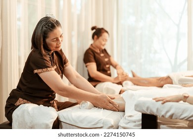 Masseuse mature asian woman working massage service in spa salon, Foot and leg massage customer. Relaxing massage in spa salon concept. - Powered by Shutterstock