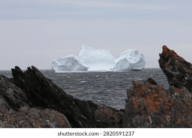 Massive arctic iceberg grounded in the shallow waters of Hay Cove, Newfoundland