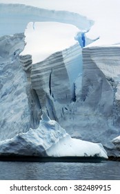 Massive Chunk Of Ice Breaking Off A Glacier To Form An Iceberg