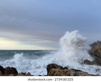 Massive explosive wave rises above giant rocky cliff, dynamic water motion, unique wave, Atlantic coast, vertical ocean wave, foamy water, dramatic coastal seascape