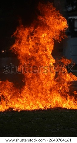 Massive flames dominate the frame in an intense fire safety demonstration. Captured outdoors, this dramatic moment highlights the power of fire and the importance of training.
