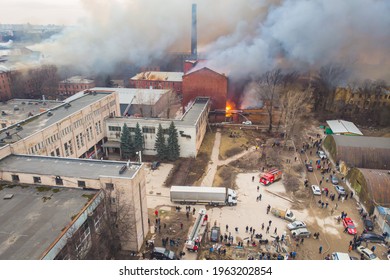 Massive large blaze fire in the city, aerial drone top view brick factory building on fire, hell major fire explosion flame blast,  with firefighters team, arson, burning damage destruction 