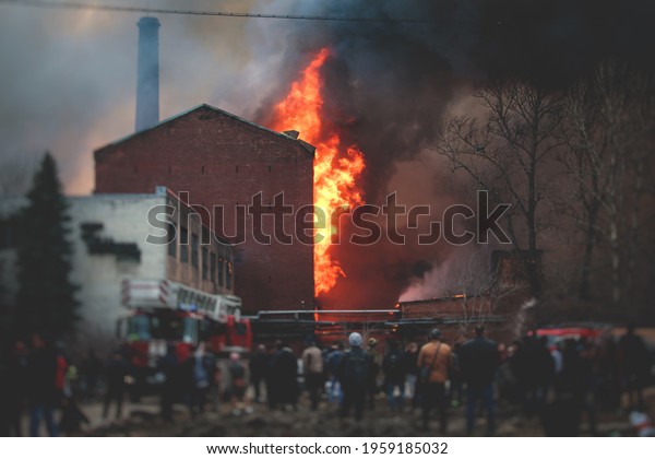 Massive\
large blaze fire in the city, brick factory building on fire, hell\
major fire explosion flame blast,  with firefighters team firemen\
on duty, arson, burning house damage destruction\
