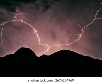 Massive lightning over mountain range on a stormy summer night
