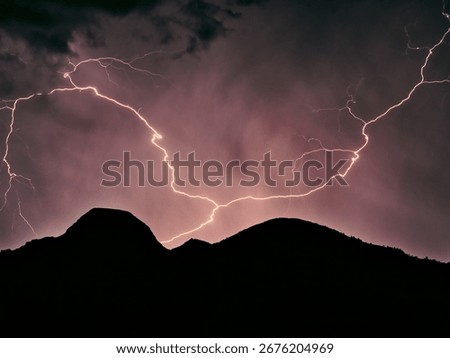 Massive lightning over mountain range on a stormy summer night