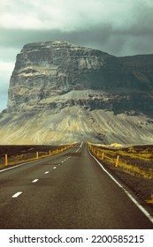 Massive Mountain With Canyon On Iceland, End Of An Infinite Road. View From The Road During A Trip Through Icelandic Wild Areas. Boho Backpacking Traveling Style, Nature Background Concept. Colorful