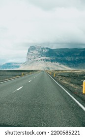 Massive Mountain With Canyon On Iceland, End Of An Infinite Road. View From The Road During A Trip Through Icelandic Wild Areas. Boho Backpacking Traveling Style, Nature Background Concept. Colorful