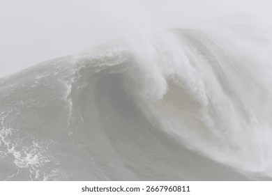 Massive ocean wave breaking, generating white frothy foam during stormy weather, revealing powerful natural force and intense marine dynamics
