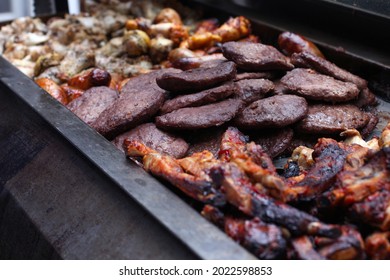 Massive Pile Of Cooked Bbq Meats At A Barbecue Cook Out On The Grill