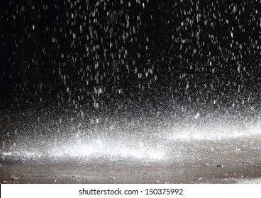 Massive rainfall on asphalt from a broken gutter under a cloudburst - a concentrated rain day