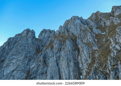 Massive rock wall of mount Eisenerzer Reichenstein in Styria, Austria, Europe. Austrian Alps. Bare and sharp mountain ridges of the Ennstaler Alps. Extreme climbing, mountaineering adventure. Sunny