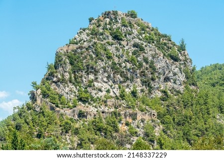 A massive rocky hill with the ruins of Alara Castle in Alanya, Turkey. The castle dates from the 13th century.