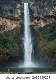 A massive, sheer cliff face frames a dramatically high waterfall plunging into a turquoise pool, with a few small people at the base.