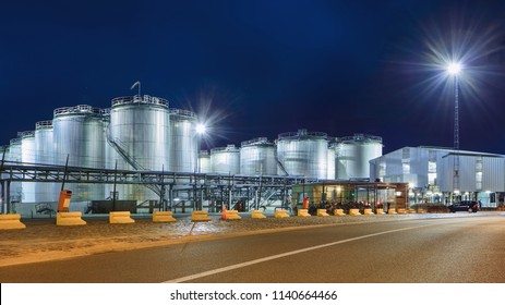 Massive Tanks At Illuminated Petrochemical Production Plant At Nighttime, Port Of Antwerp, Belgium.