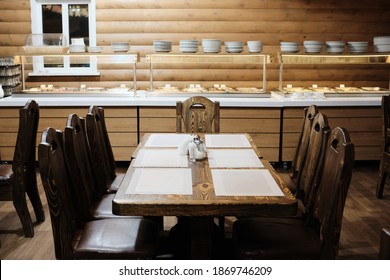 Massive Wooden Table In The Dining Room. The Concept Of A Vacation In A Country Club.