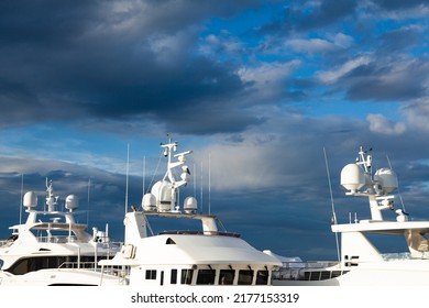 Mast of a large luxury yacht with navigation equipment, bottom view. Radars, signal lights, satellite dishes and equipment.