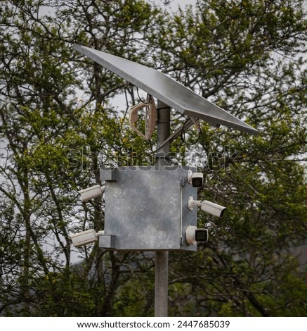 Mast with power source, tracking and transmitting devices in protected natural areas. Complex of video cameras and motion sensors with solar panel and anantenna transmitting signal from the control